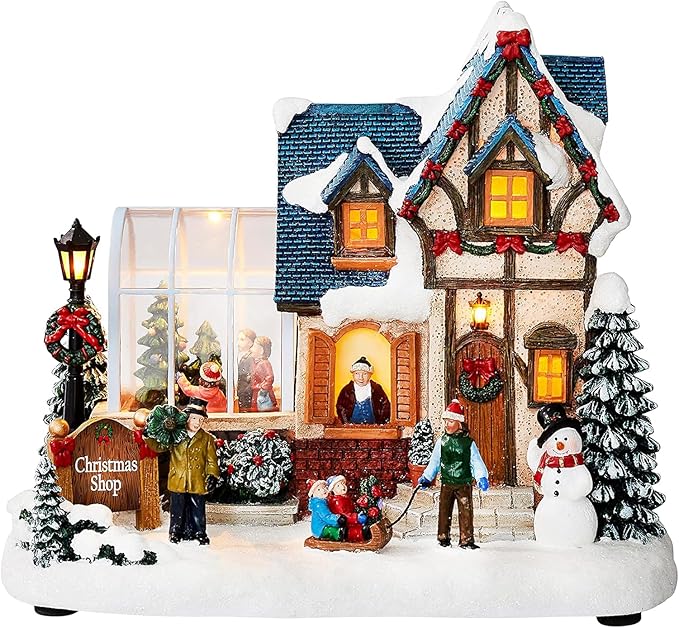 MOMENTS IN TIME Christmas Village Building Lighted Christmas Shop with LED Lights, Music & Snowman Battery Operated or Plug-in Vintage Holiday Village House Décor 8.5”H x 9.8”W x 6.9”D